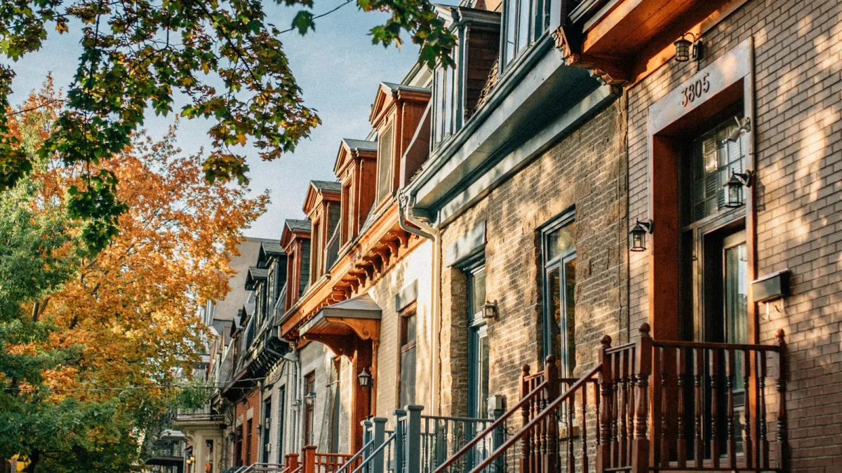 A row of Montreal houses with their outdoor staircases, in autumn